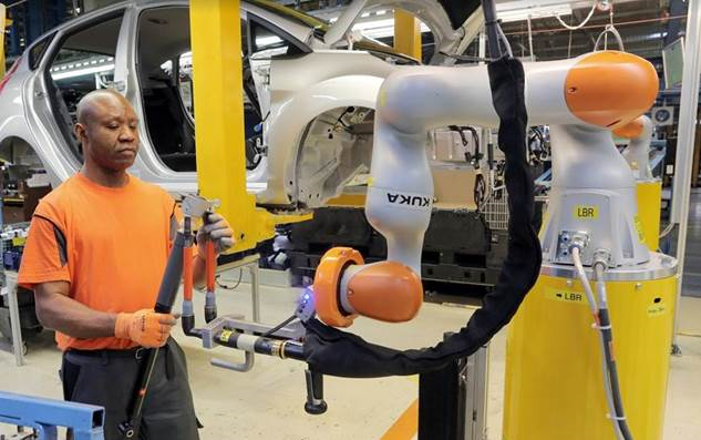 kuka robots Car workers buddy up with robots – man and machine work hand-in-hand as Ford applies industry 4.0 automation