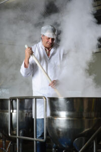 Guy stirring pan 1 REDUCING YOUR OFF-GRID CARBON FOOTPRINT