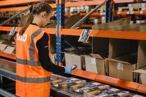 Woman scanning warehouse shelves, ahead of National Logistics Day 2025